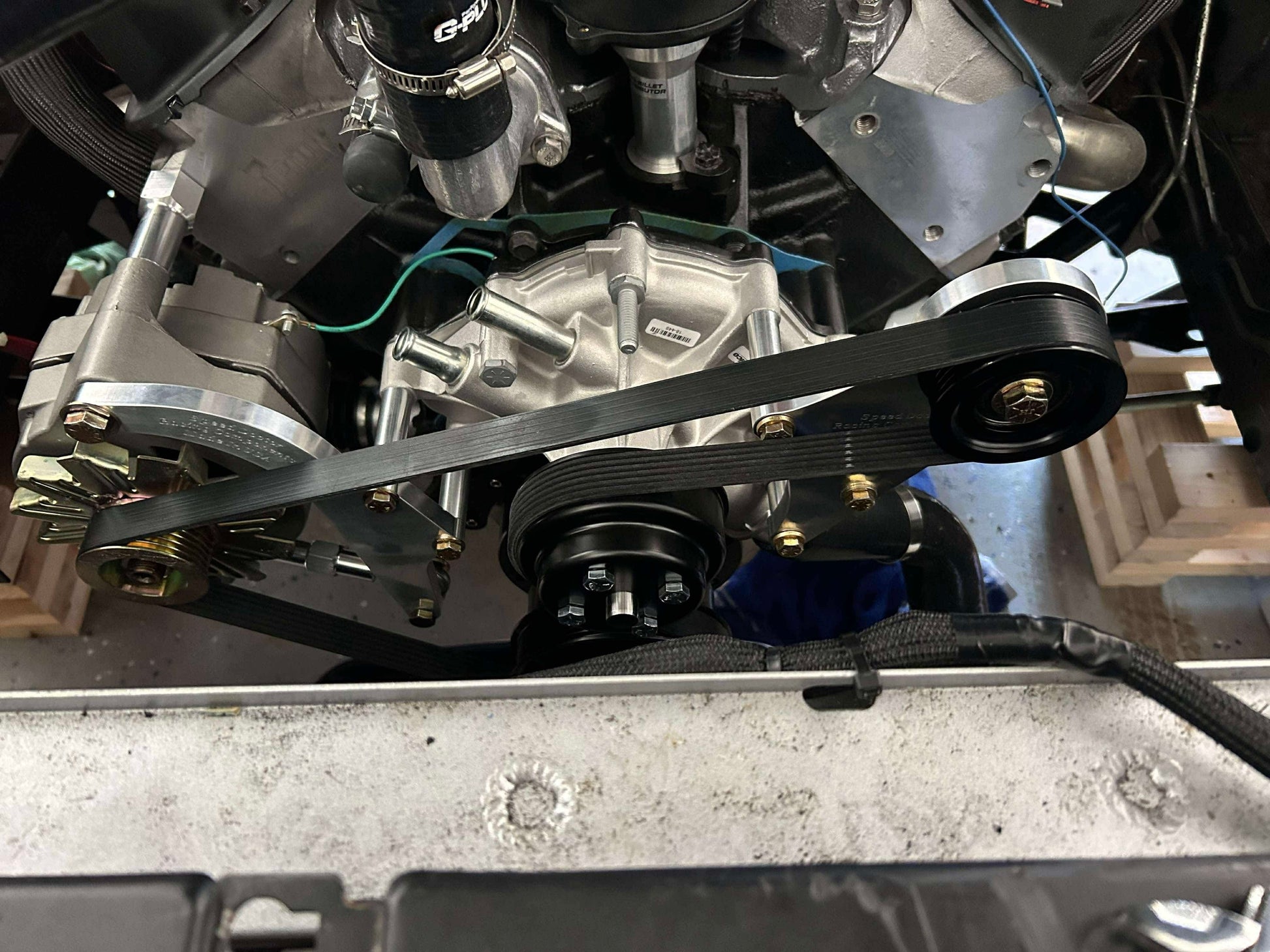 Vehicle engine bay showing installed AC delete kit