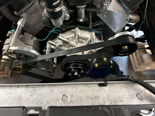 Vehicle engine bay showing installed AC delete kit